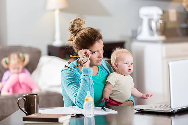 Frustrated mom studies for college exam stock photo