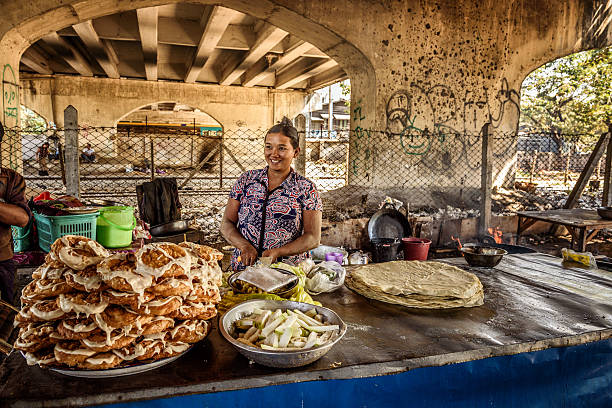 woman cooking street food in yangon myanmar picture - Where To Start with Traveling and More