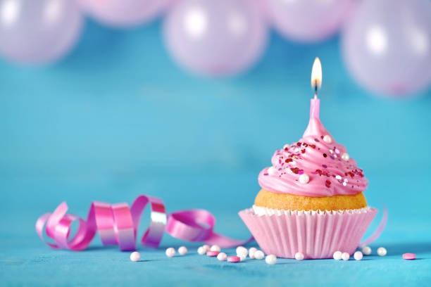 istock Happy birthday cake cupcake with burning candle 1000002804
