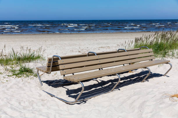 istock Empty bench in dunes by sea on a Sunny day.Baltic sea 1000008984