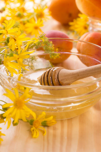 istock Honey stick and a glass jar 1000037098