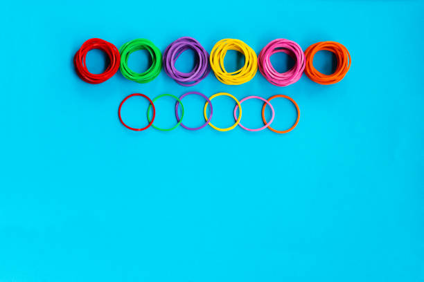 istock Teamwork concept. group of colorful rubber band on blue background with copy space 1000059682