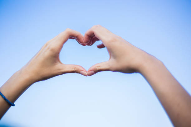 istock Girl holding a heart shape with hands 1000060070