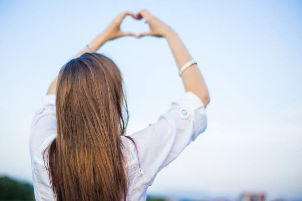 istock Girl holding a heart shape with hands 1000063568