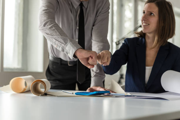 istock Successful architect knocking fists in celebration 1000078728