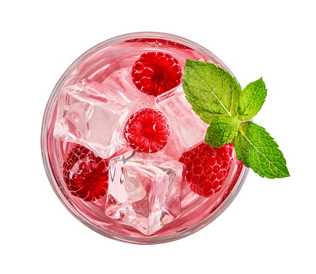 Glass of pink soda drink with ice and raspberry isolated on white background, top view