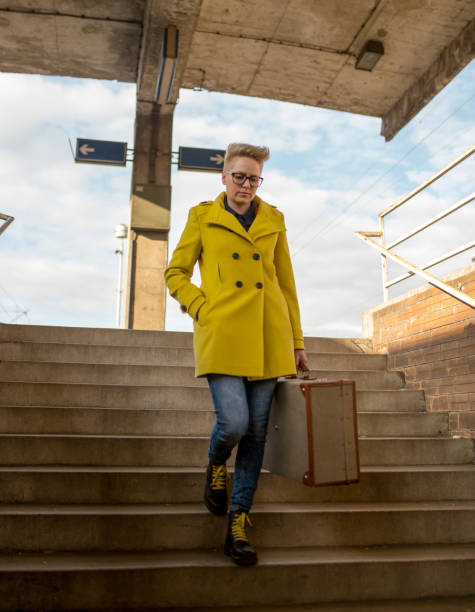 istock young girl walking along railway station, 1000088938