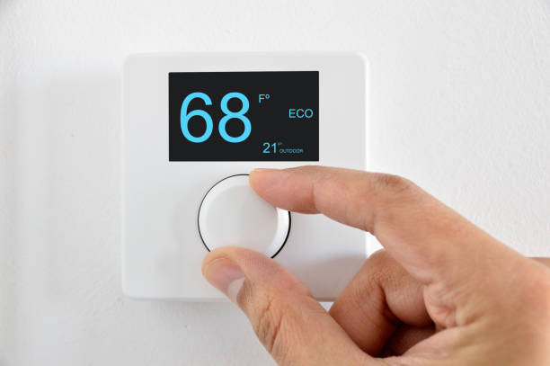 digital thermostat One hand adjust thermostat digital in fahrenheit at home fahrenheit stock pictures, royalty-free photos & images