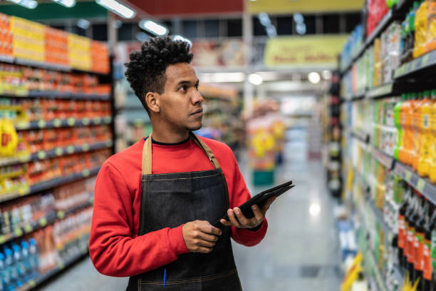 istock Businessman checking inventory in a digital tablet at a supermarket 1000124604