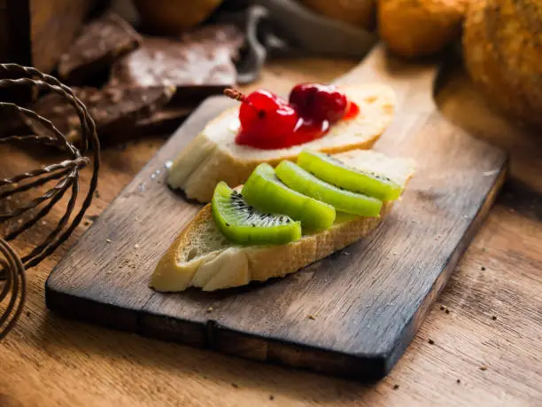 Photo of Toasts bread with fresh kiwi fruit, home made breakfast. Selective focus.