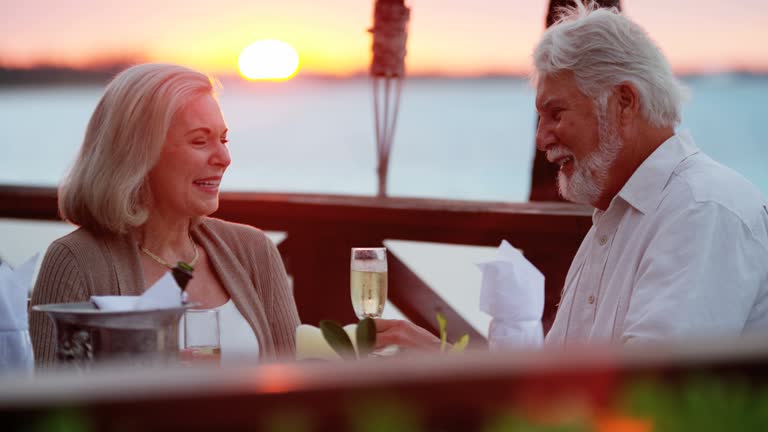 Senior Caucasian couple dining at tropical resort hotel