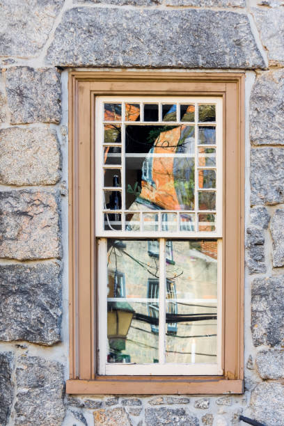 Reflections on the Window of an Old Stone House In Ellicott City Maryland Reflections from the town of Ellicott City Maryland on an old window in a stone house. ellicott city maryland stock pictures, royalty-free photos & images