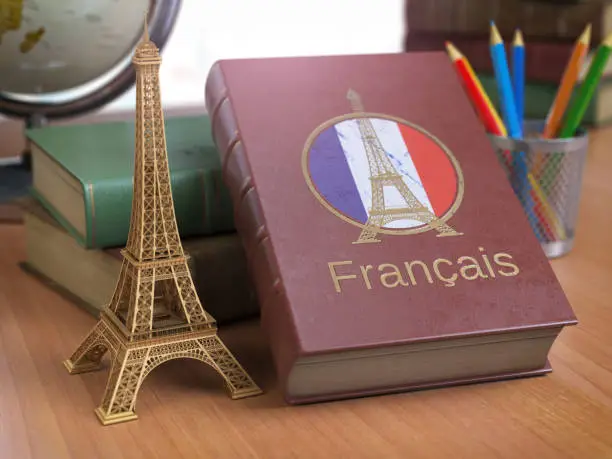 Learn and studiyng French concept. Book with  French flag and Eiffel tower on the table. 3d Iluustration