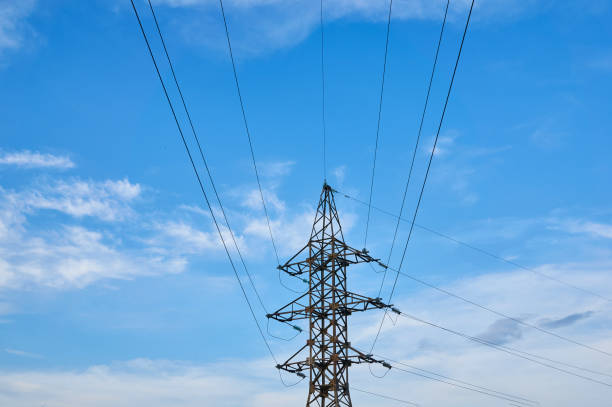 istock A line of high-voltage cables against a blue sky with clouds. 1000159750