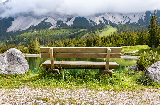 Bench near Almsee lake in the Alps mountains - Tyrol, Austria. Beautiful view on a sunny day