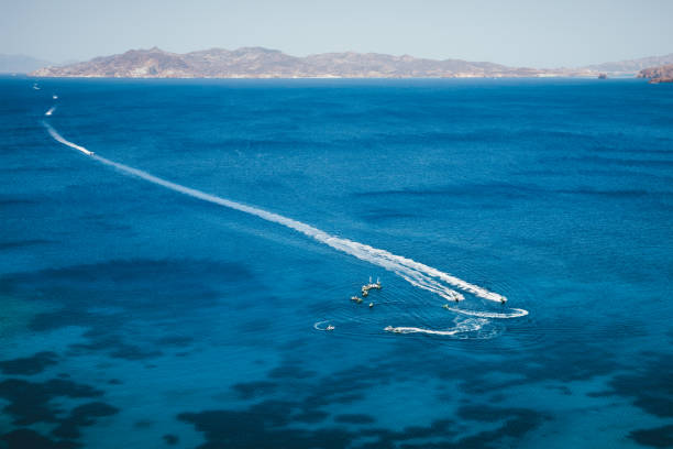 Group of tourists using jet skis in Milos. Aerial view (Cyclades, Greece).