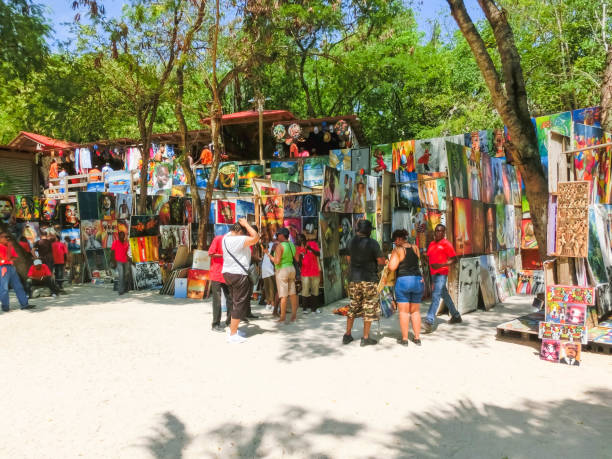LABADEE, HAITI - MAY 01, 2018: Handcrafted Haitian souvenirs sunny day on beach at island Labadee in Haiti LABADEE, HAITI - MAY 01, 2018: Handcrafted Haitian souvenirs and painting at sunny day on beach at island Labadee in Haiti labadee stock pictures, royalty-free photos & images