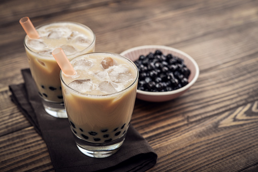 Homemade Milk Bubble Tea with Tapioca Pearls on wooden background