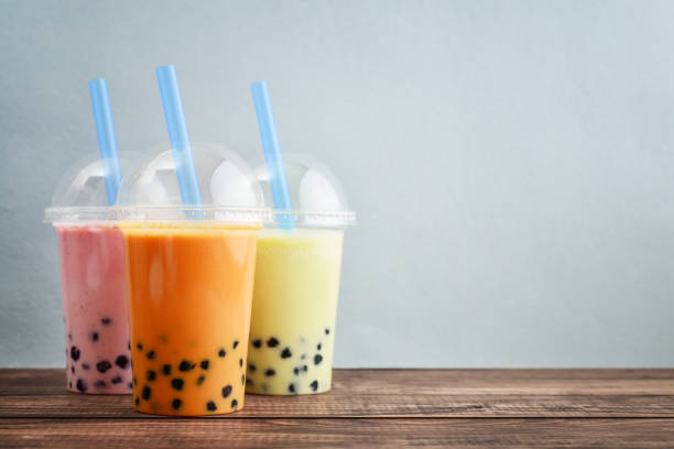 Various Bubble Tea Various Bubble Tea in a plastic cups with drink straws on blue background. Take away drinks concept. bubble tea photos stock pictures, royalty-free photos & images