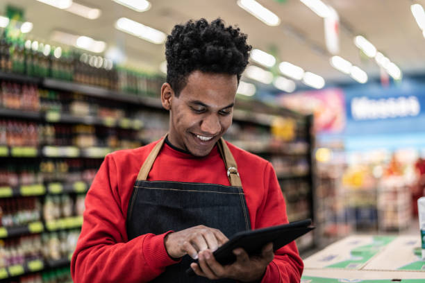 istock Businessman checking inventory in a digital tablet at a supermarket 1000167816