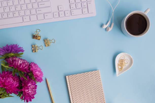 istock Blogger or freelancer workspace with notebook and pink flowers 1000168720