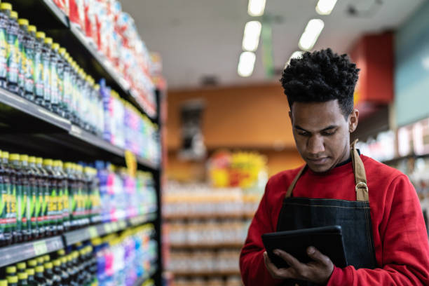 istock Businessman checking inventory in a digital tablet at a supermarket 1000168930
