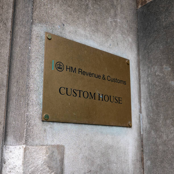 Sign outside HM Revenue & Customs 'Custom House', London A metal sign on the wall outside HM Revenue & Customs 'Custom House' in London. Custom House in on the north bank of the River Thames. hm government stock pictures, royalty-free photos & images