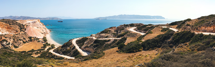 Winding country road leading to Tria Pigadia beach in Milos.