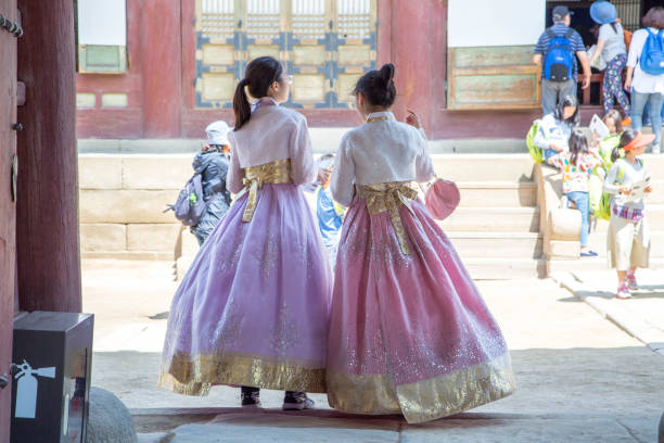 A pair of women wearing traditional Korean hanbok for a visit to the Gyeongbokgung Palace in Seoul.