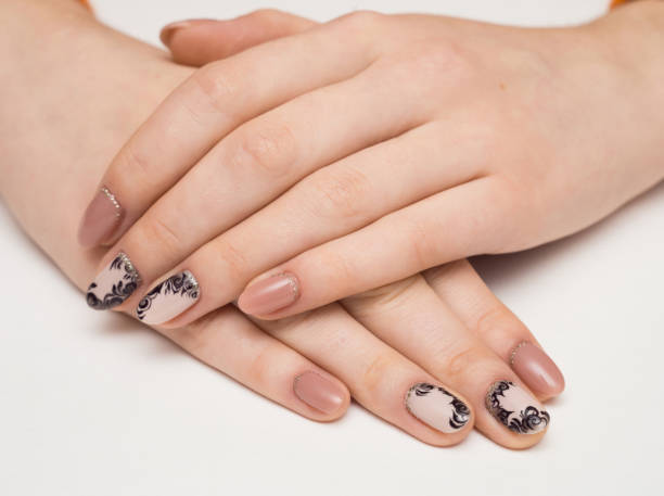 istock Hands with manicured nails covered with pink nail polish on fur background 1000238658