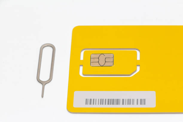 istock Modern yellow sim card with clip, closeup 1000241844