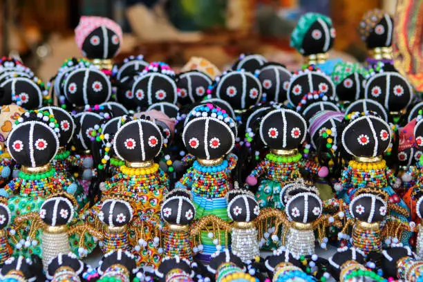 Photo of Traditional ethnic African handmade dolls with multicolored bead decoration at local market in Cape Town, South Africa. Souvenirs from Africa