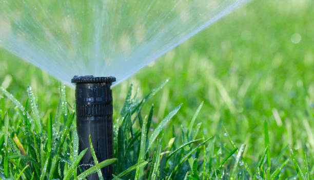 istock automatic sprinkler system watering the lawn on a background of green grass 1000250050