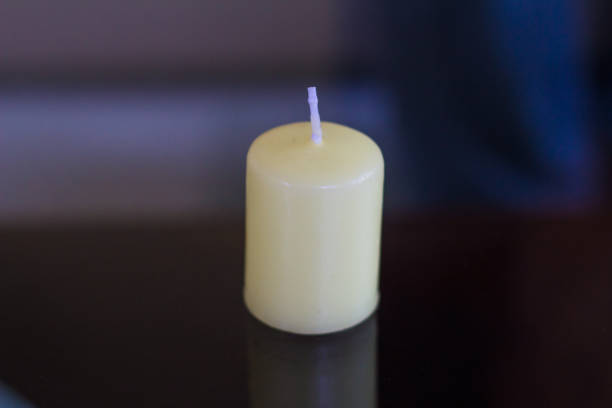 istock close-up of white candle on table 1000250516