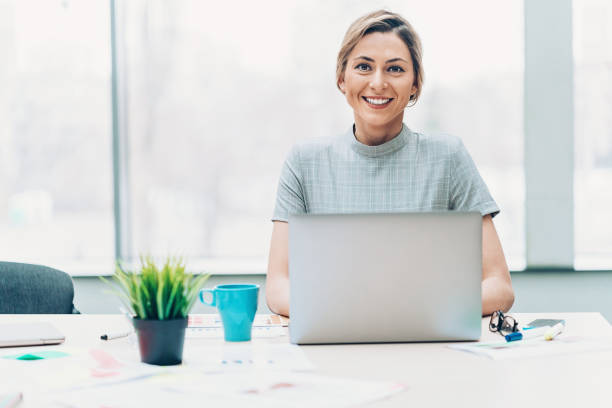 istock Smiling businesswoman in her office 1000250572
