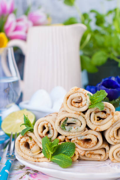 Homemade pancakes with mint and lime. Traditional Russian spring pastries. Delicious family breakfast. Cooking for carnival. Card.