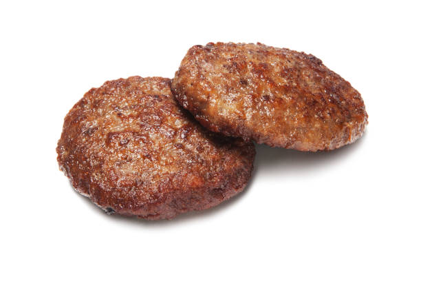 istock Two fried hamburger patties isolated on white 1000270756