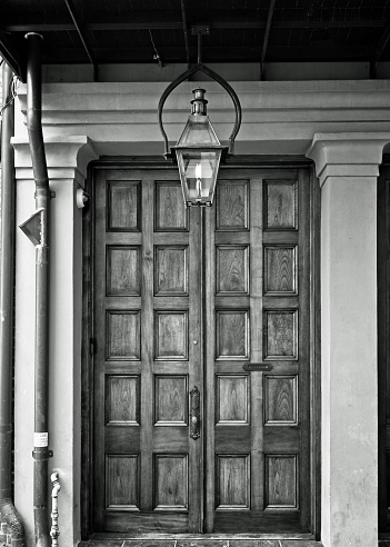 New Orleans, LA USA - May 9, 2018  -  Entrance Door with Gas Lamp B&W