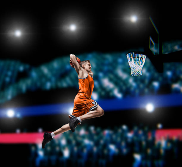 istock basketball player making slam dunk on basketball arena 1000302704