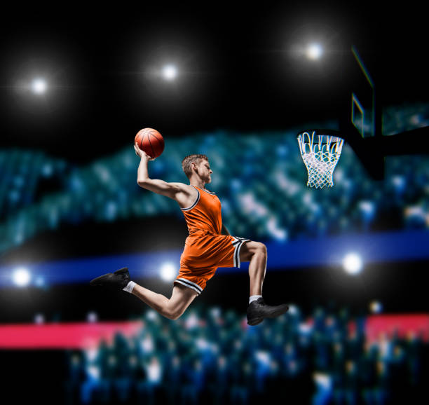 istock basketball player making slam dunk on basketball arena 1000304766