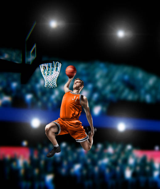 istock basketball player making slam dunk on basketball arena 1000304840