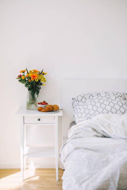 istock Breakfast and flowers on the bedside table 1000376742
