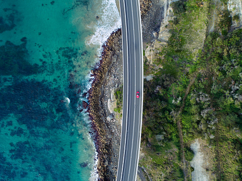 Aerial photograph of a car driving through the Sea Cliff Bridge, New South Wales