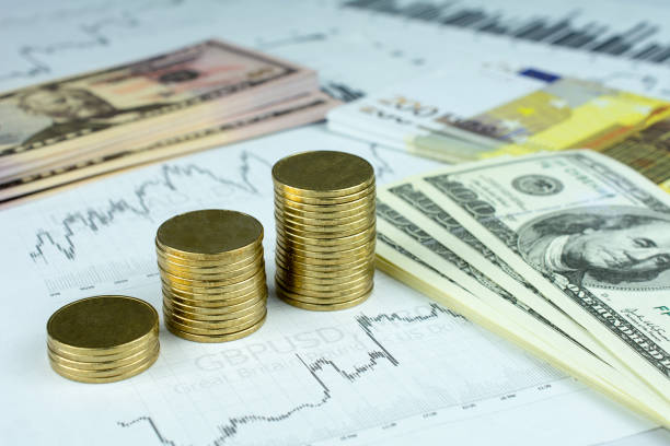 istock Personal saving, piles of gold coins on dollar bills 1000389814