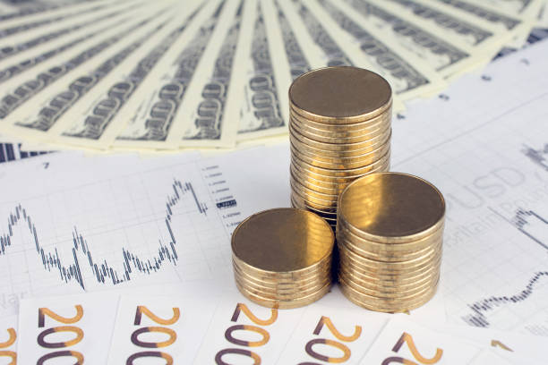 istock Personal saving, piles of gold coins on dollar bills 1000390284