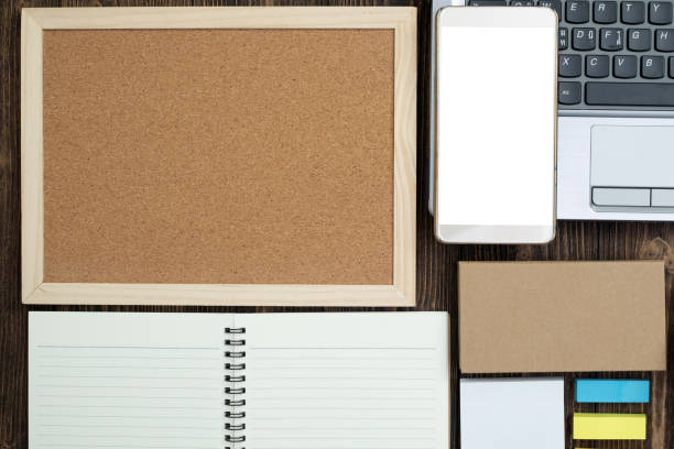 istock Office supplies or office work essential tools or items on wooden desk in workplace, top view with copy space for add text. 1000410590