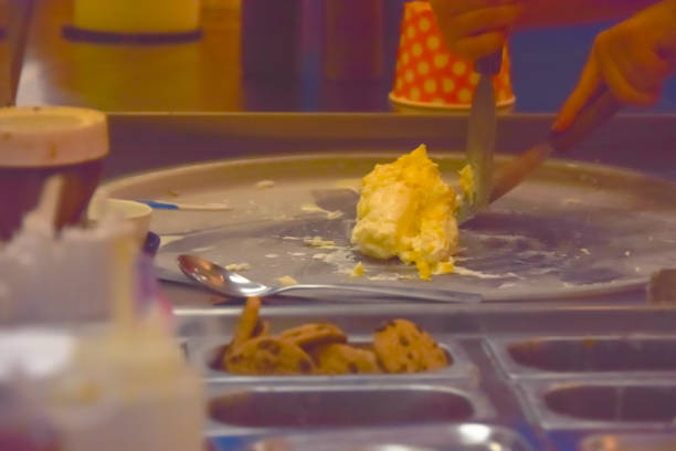 Thailand roll ice cream made by hand on the freezer pan. Sweet dessert made from coconut and natural ingredients. The process of making food
