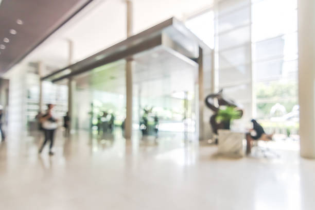 istock Hotel or office building lobby blur background interior view toward reception hall, modern luxury white room space with blurry corridor and building glass wall window 1000411214