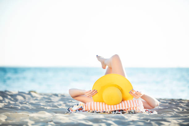 Young Woman Relaxing and Sunbathing at Beach