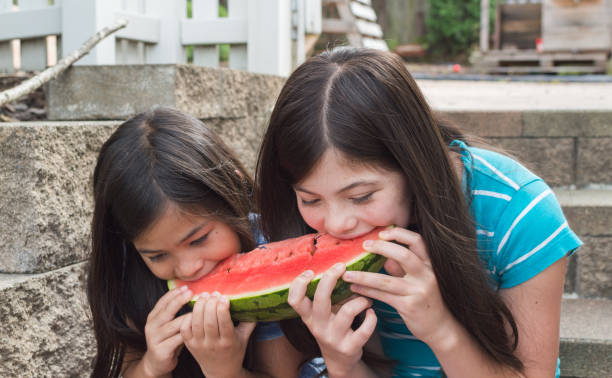 istock Girls eating watermelon in summer 1000483856